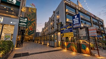 A hotel with multiple floors, a classic cinema, and a restaurant with a tropical mural.