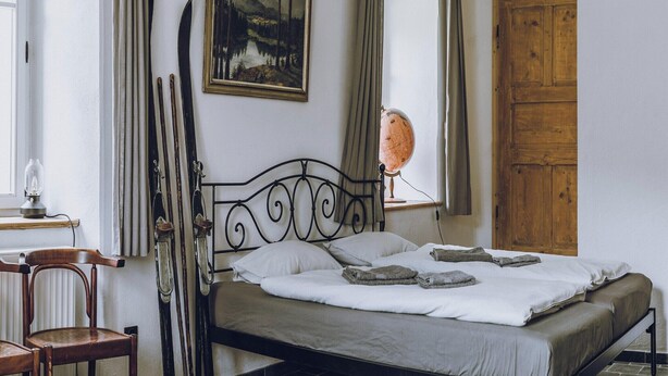 A bedroom with a bed, a wooden wardrobe, a globe, and a painting on the wall. - Holiday Homes with Sokolik Mountain Views (Janowice Wielkie)
