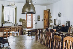 A rustic dining area with wooden furniture, a stone wall, and a vintage coffee machine. - Minimalist Home near Forest (Janowice Wielkie)
