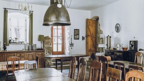 A rustic dining area with wooden furniture, a stone wall, and a vintage coffee machine. - Nature Retreat near Janowice (Janowice Wielkie)