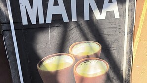 A sign with the word 'MATKA' and a picture of three cups, likely indicating a place serving matka.