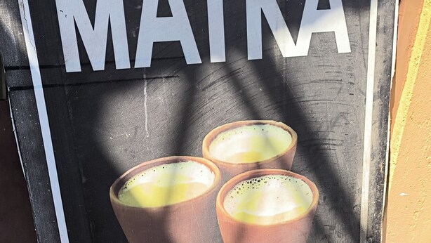 A sign with the word 'MATKA' and a picture of three cups, likely indicating a place serving matka.