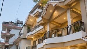 A multi-story building with balconies, a reception area, and a sign indicating a retreat.