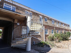 A multi-story building with a staircase leading to the upper floors. - 16 Old Shipyard Centre (Bridport)