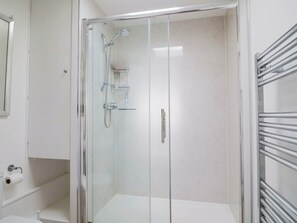 A glass-enclosed shower stall with a handheld showerhead and a wall-mounted faucet. - 16 Old Shipyard Centre (Bridport)