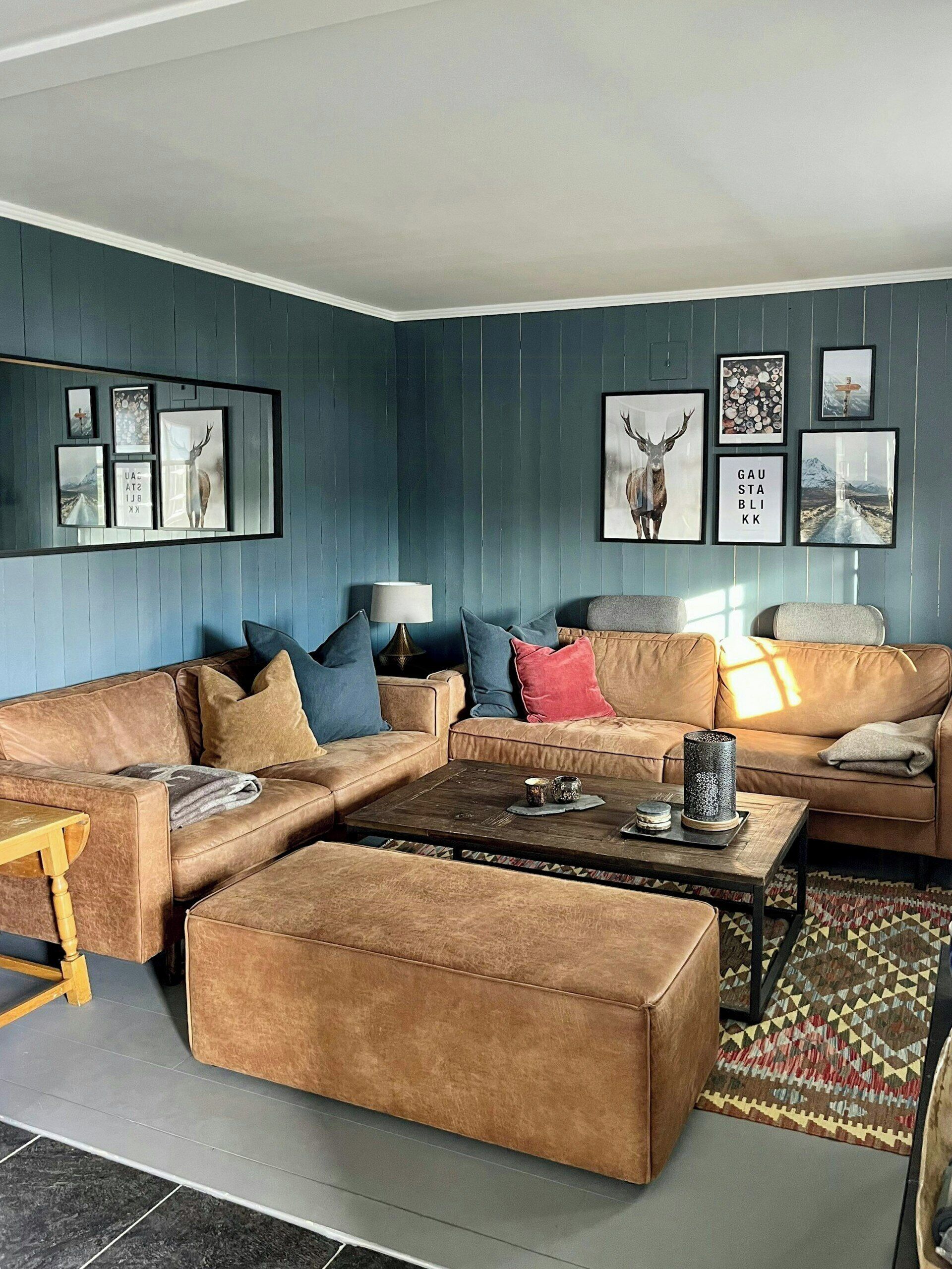 A living room with a sectional sofa, a coffee table, and a patterned rug.