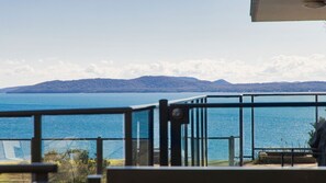 A view of a body of water with a distant landmass and a metal railing in the foreground. - The Poplars Apartment with views and  Swimming Pool (Nelson Bay)