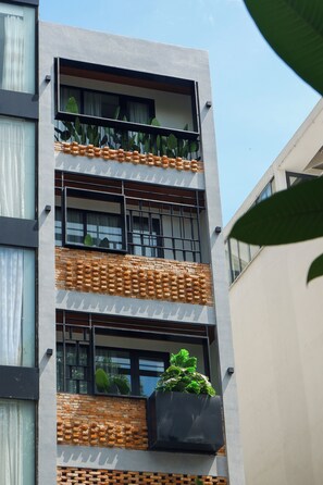 A multi-story building with balconies, windows, and a brick facade. - CityHouse NEST Dien Bien Phu (Ho Chi Minh City)
