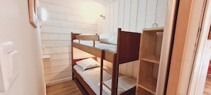A bunk bed room with wooden walls and a door. - Charming apartment for 6 people with a mountain view (Les Deux Alpes)