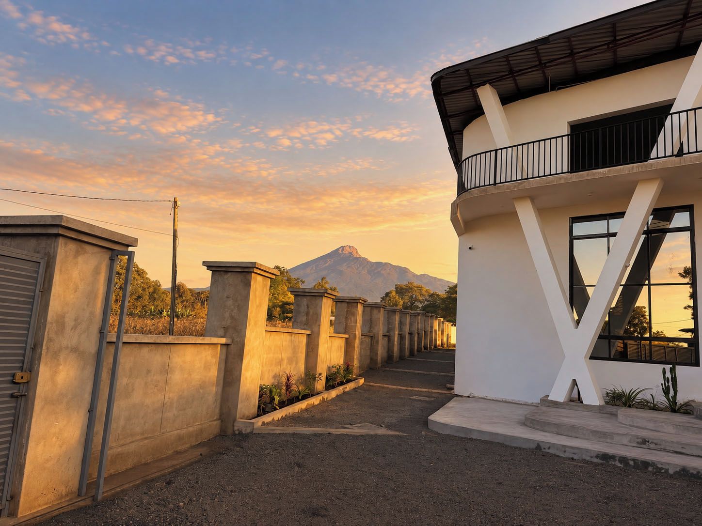 A modern building with a balcony and a view of a mountain.