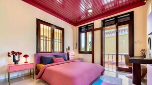 A bedroom with a bed, bedside table, and a window with a view. - Xao xac Homestay (Da Nang)