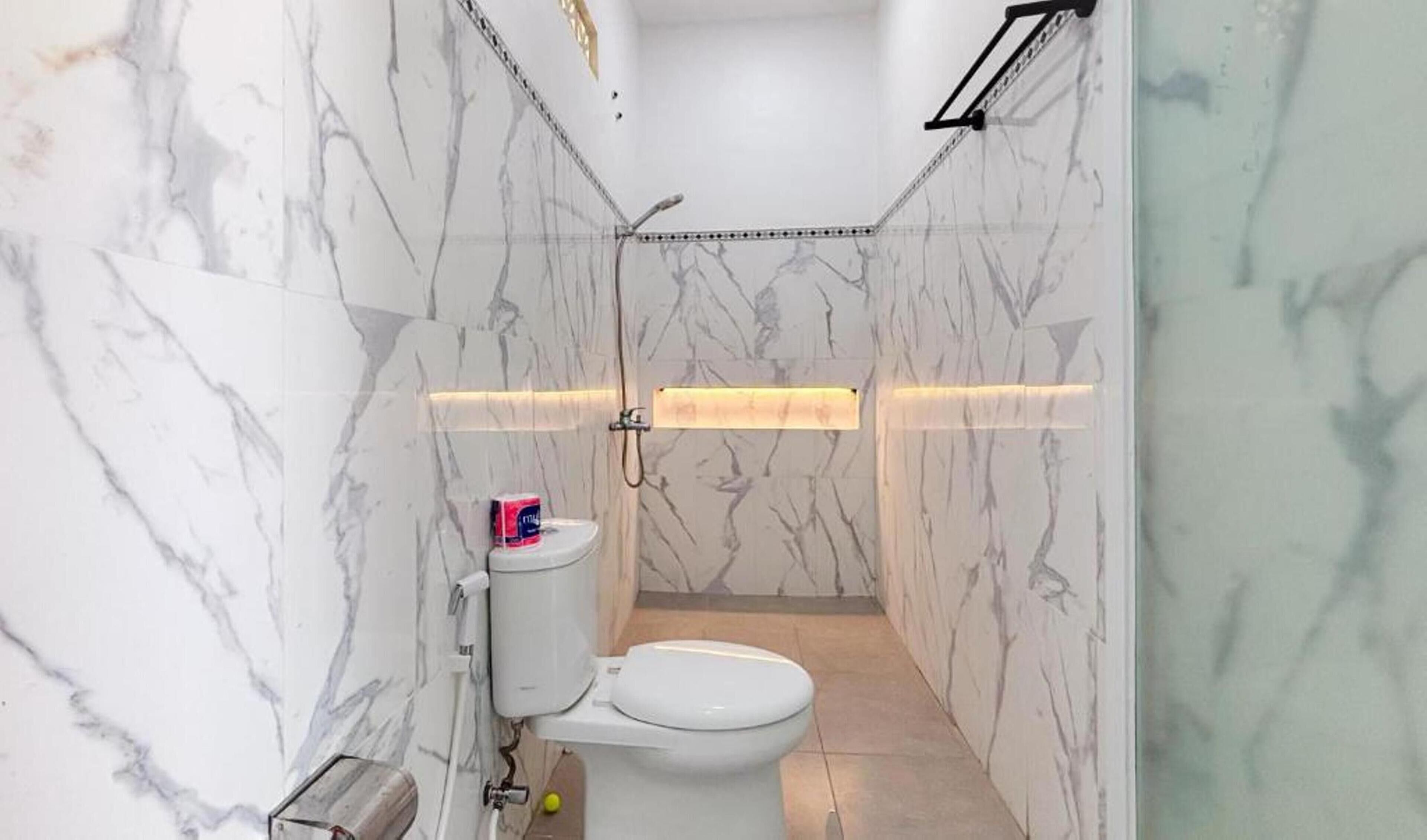 A bathroom with a toilet, a bidet, and a shower area.
