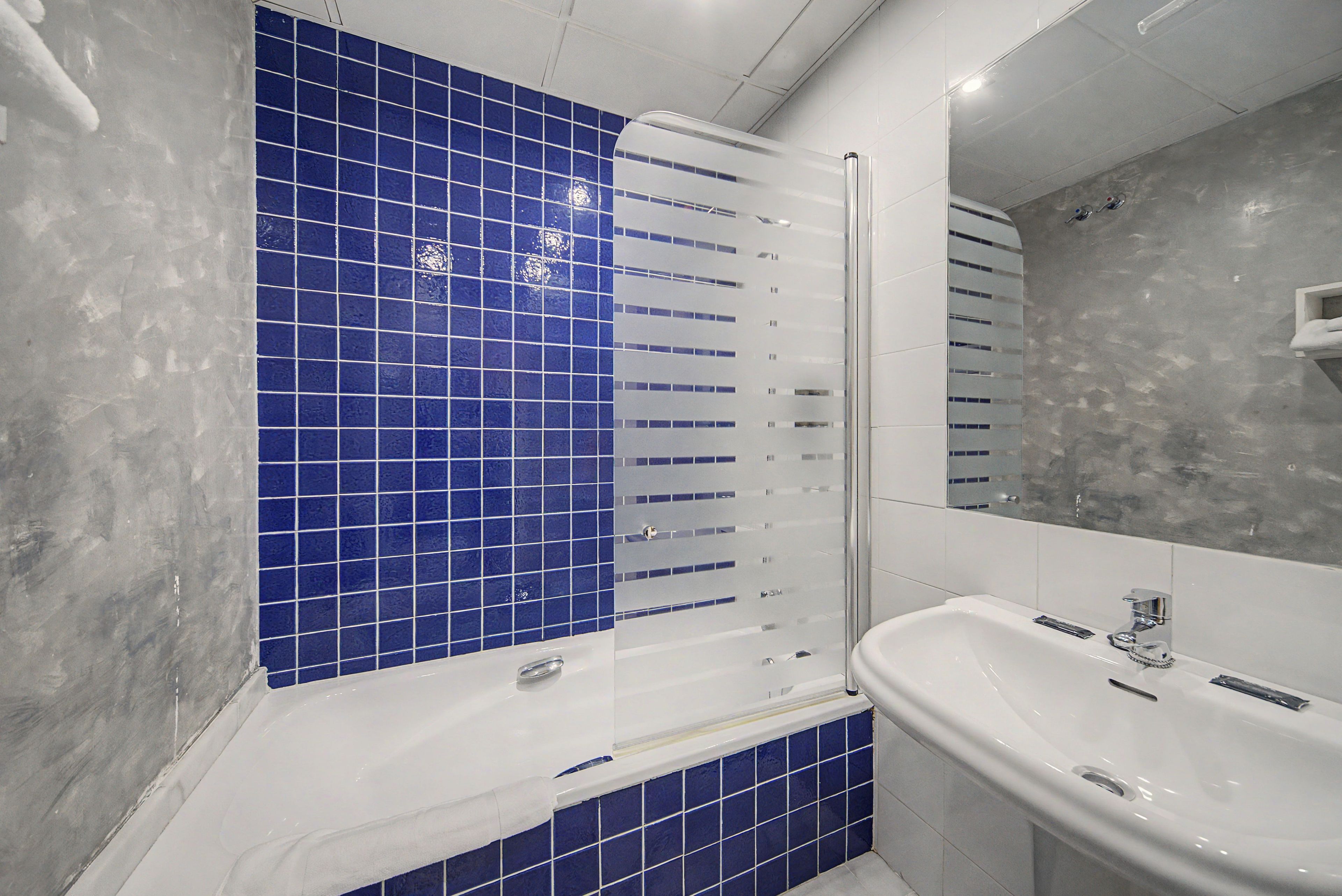 A bathroom with a bathtub, a shower, and a sink.