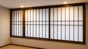 A room with a traditional sliding door with frosted glass panels and a wooden frame.