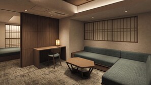 A room with a sofa, a desk, and a chair.