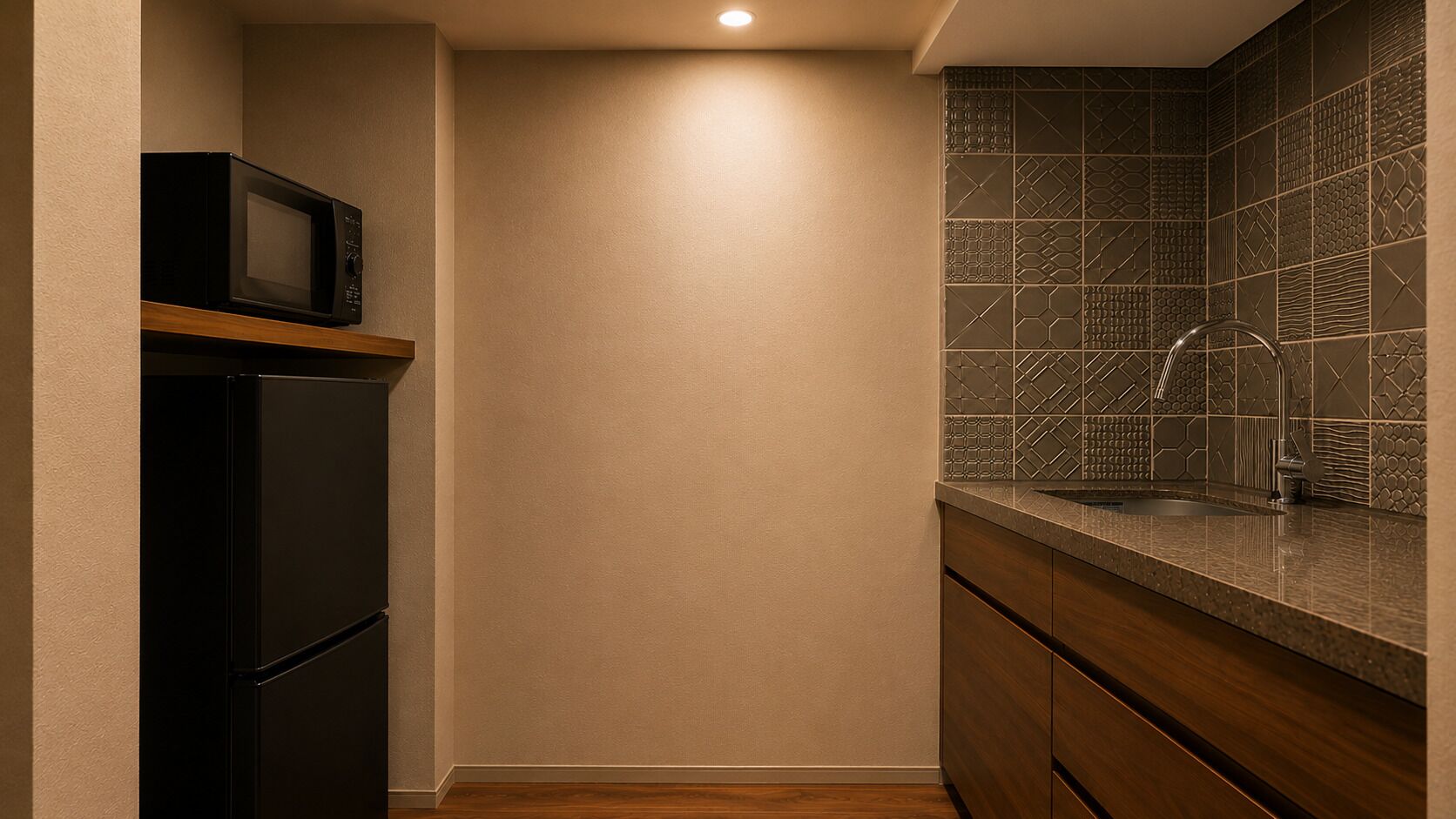 A kitchen with a microwave, a sink, and a tiled backsplash.