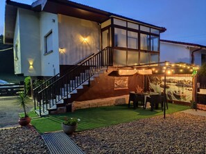 A two-story house with a staircase, outdoor seating, and a mural on the wall. - La Casa de Ruri 5926 Lodging (Isla)