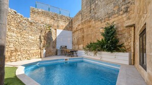 A swimming pool with stone walls and a barbecue area. - 3BR Townhouse with Private Pool & BBQ in Birkirkara (Birkirkara)