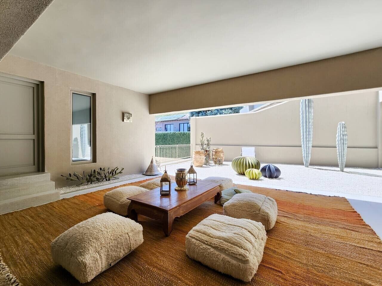 A spacious living room with a wooden coffee table, plush poufs, and decorative items.