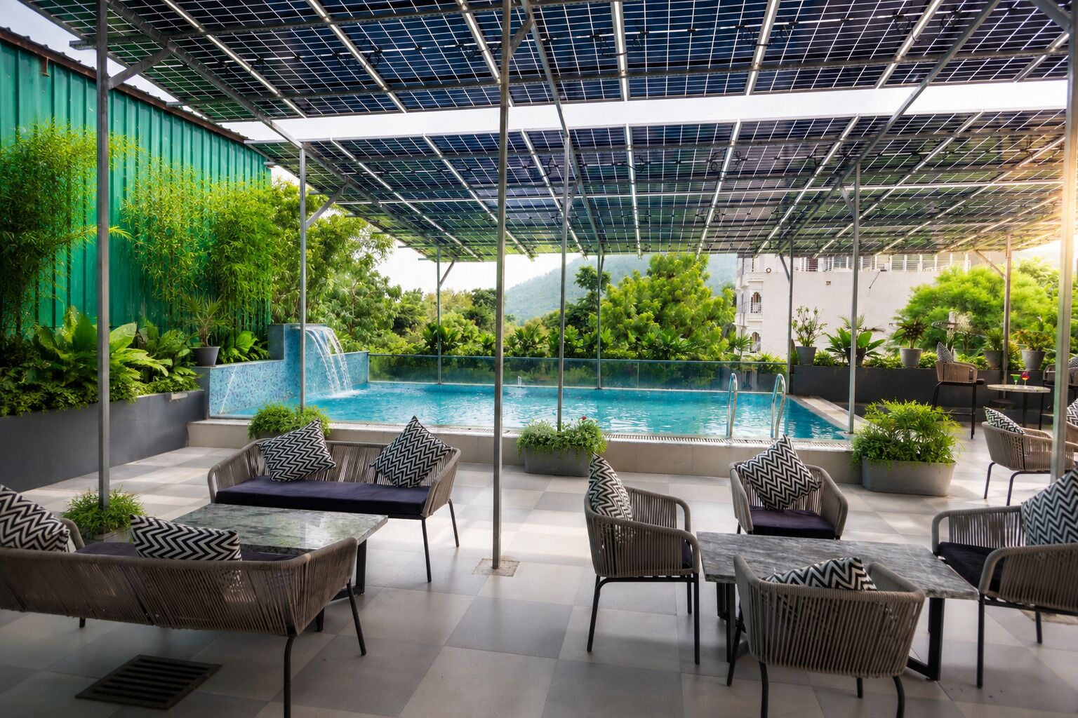 Un patio exterior con piscina, rodeado de muebles de mimbre y plantas en macetas.