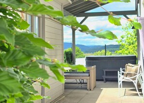 An outdoor patio with a seating area, a barbecue grill, and a view of the landscape. - Hot Tub & View of the Dolomites on the Eifelsteig Trail (Gerolstein)