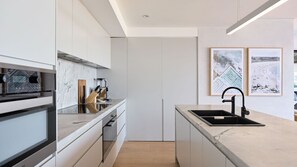 A modern kitchen with a built-in oven, a coffee machine, and a sink. - Salt Ridge North Bondi (North Bondi)