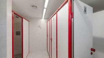 A hallway with lockers, a door marked with the number 4, and a tiled floor.