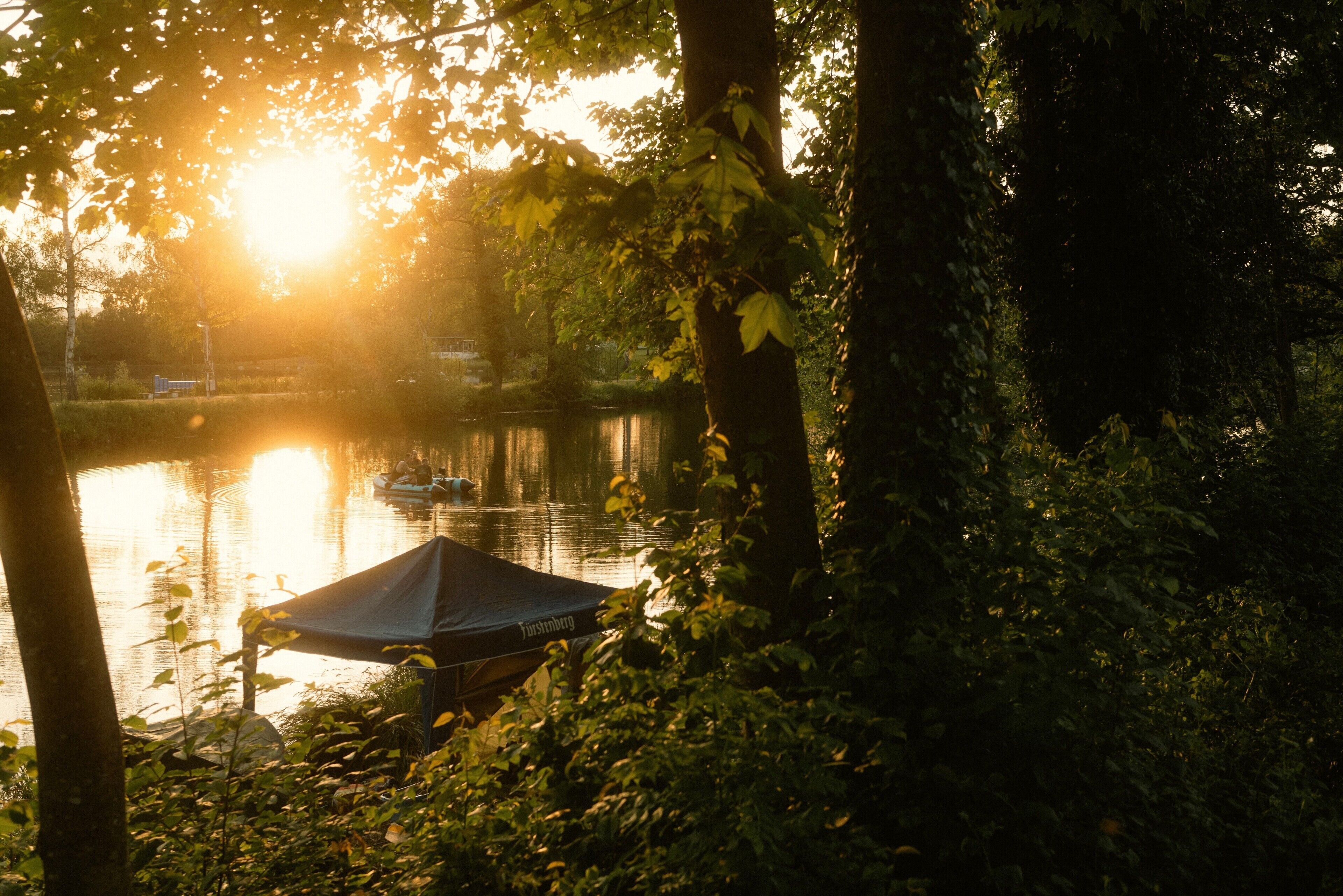 A lake with a tent and a boat.