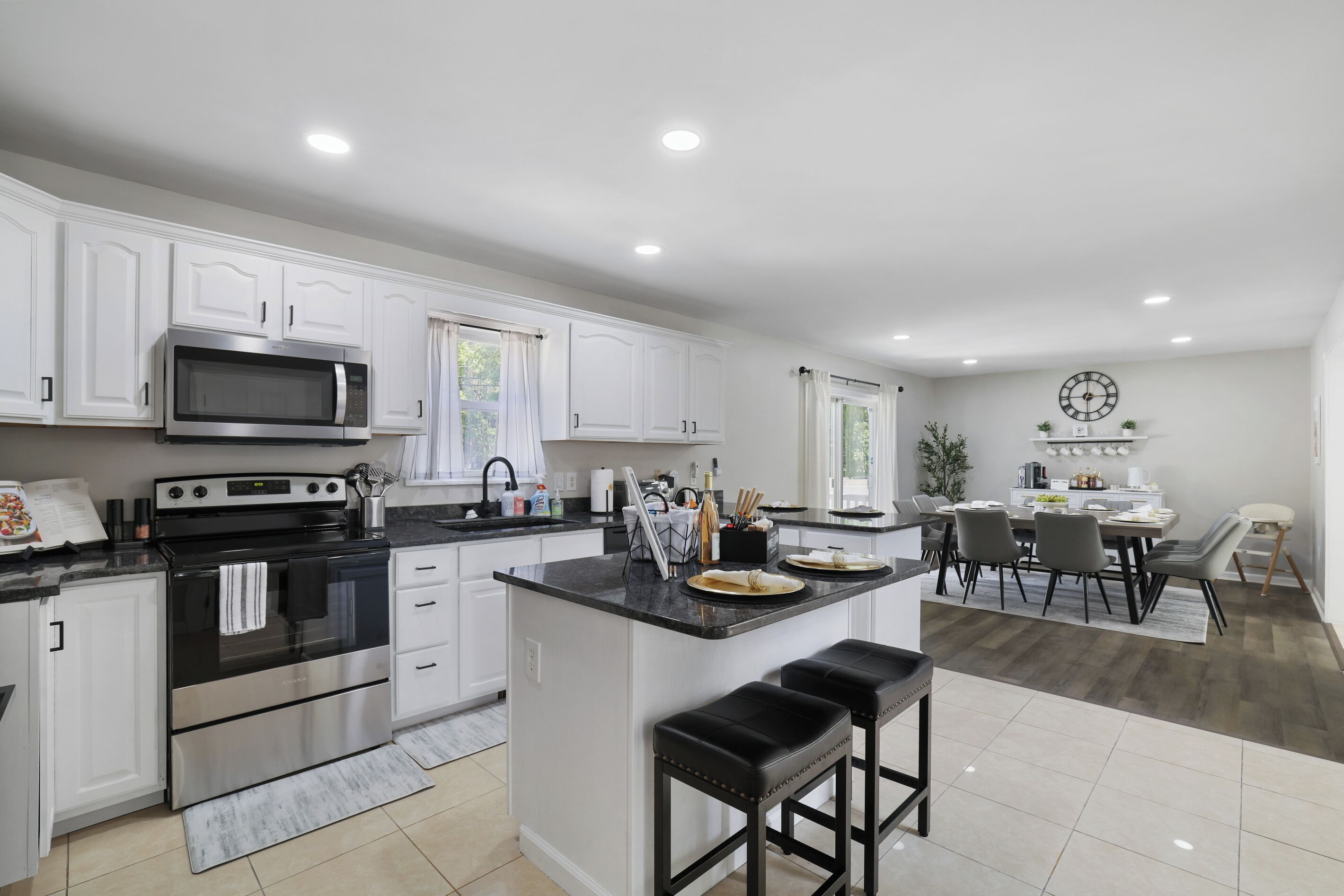 A modern kitchen with white cabinetry, a built-in microwave, and an oven.