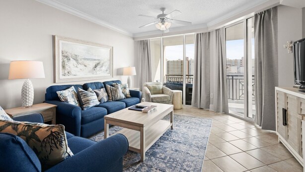 A living room with a sofa, coffee table, and a television. - Ocean Drive. 3 bedroom 3 bath condo with an OCEAN VIEW (from side). Sleeps 10. (North Myrtle Beach)