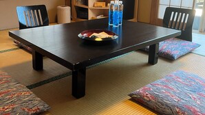 A tatami mat room with a low table, chairs, a television, and a small refrigerator. - ARASAWAYA RYOKAN (Okutama)