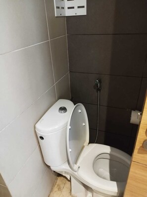 A small, compact bathroom with a toilet and a shower. - Studio meublé à bèlvedère (Casablanca)