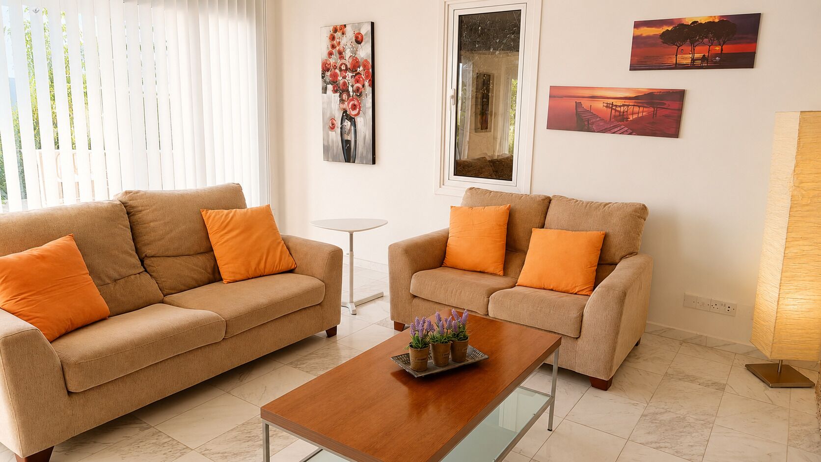 A living room with two sofas, a coffee table, and wall art.
