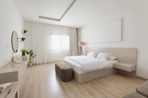A modern bedroom with a bed, bedside table, lamp, and a large window with curtains. - Premium 3BR Residence in Sodic Eastown, New Cairo /Sleeps 8 (Cairo Governorate)