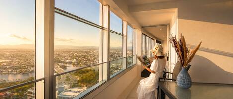 A modern interior with large windows offering a city view.