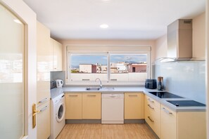 A compact kitchen with a washing machine, a dishwasher, a sink, and a stove. - Cubo's Central Bright Marbella Apartment / urban / free wifi (Marbella)