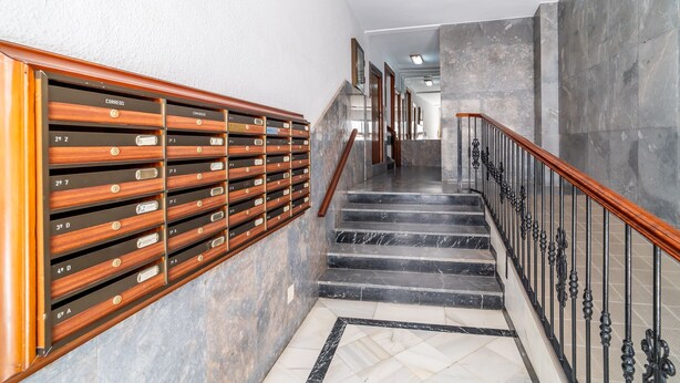A staircase with a wooden handrail and a metal railing, leading to an upper floor. - Cubo's Central Bright Marbella Apartment / urban / free wifi (Marbella)