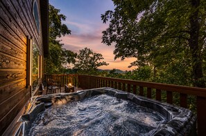 A hot tub on a wooden deck with a view of trees and hills. - Couples Winter Haven | VIEW, Barrel Sauna, Hot Tub (Sevierville)