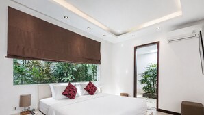 Quarto moderno com uma cama grande, janela com vista para o verde e luminária no teto.