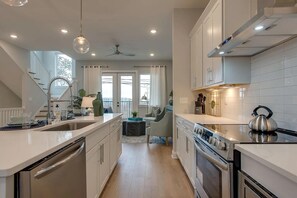 A modern kitchen with a central island, built-in appliances, and a dining area with a view. - Your Nashville home base-comfort close to downtown (Nashville)