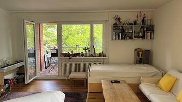 A modern living room with a sofa, a wooden table, and a piano.