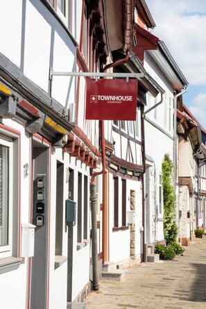 A traditional European building with a red sign indicating a townhouse.