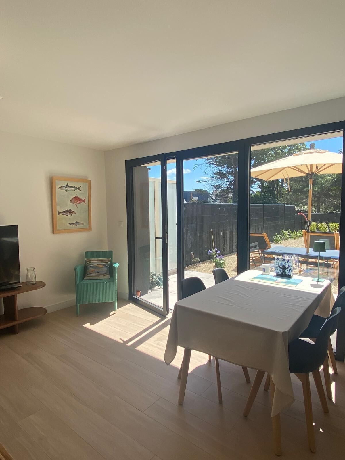 A spacious room with a large sliding glass door leading to an outdoor patio area.