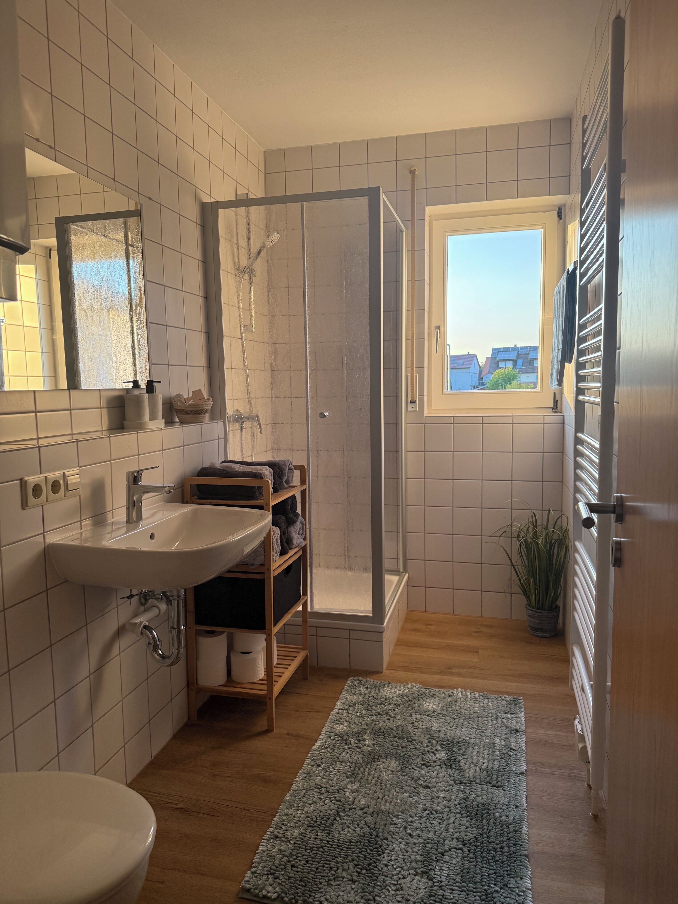 A bathroom with a shower, sink, and toilet.