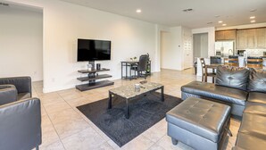 A modern living room with a flat-screen TV, a coffee table, and leather sofas. - Wfh-friendly Phoenix Home w/ Easy Freeway Access (Phoenix)