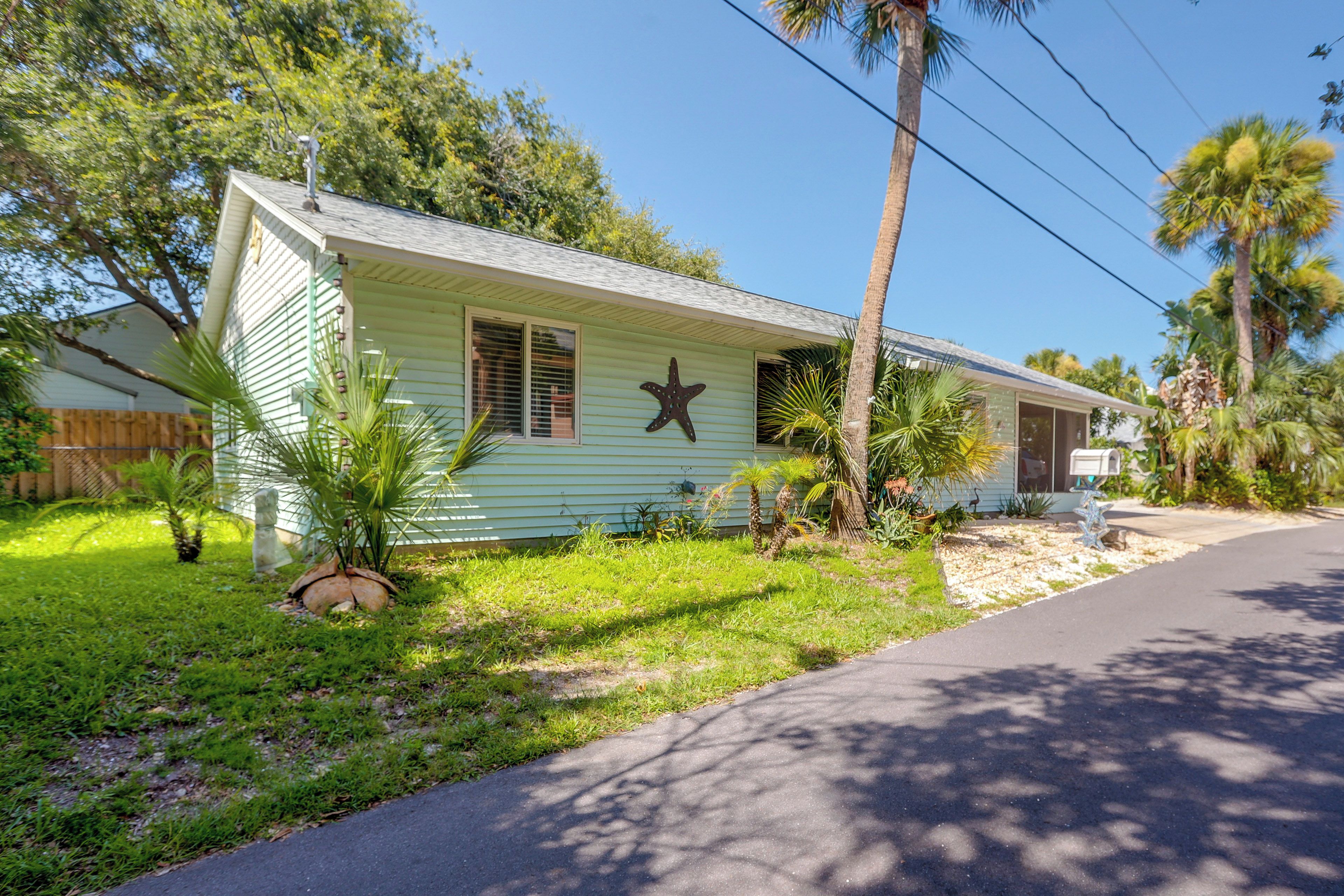 A single-story house with a front porch, a mailbox, and a star decoration on the wall.