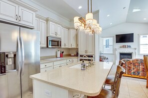 A modern kitchen with white cabinetry, stainless steel appliances, a central island, and a chandelier. - Full Kitchen! King Suite Near Snowbasin (Layton)
