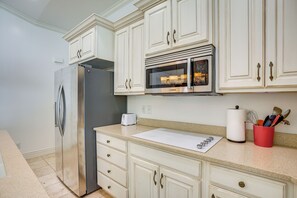 A kitchen with white cabinetry, a stainless steel refrigerator, a microwave, and a toaster. - Full Kitchen! King Suite Near Snowbasin (Layton)