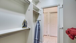 A hallway with a built-in ironing station, a drying rack, and a door leading to another room. - Full Kitchen! King Suite Near Snowbasin (Layton)