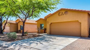 A residential area with multiple houses featuring similar architectural styles, including stucco walls and tiled roofs. - Walk to Tucson Trails! Private Yard w/ Views (Tucson)